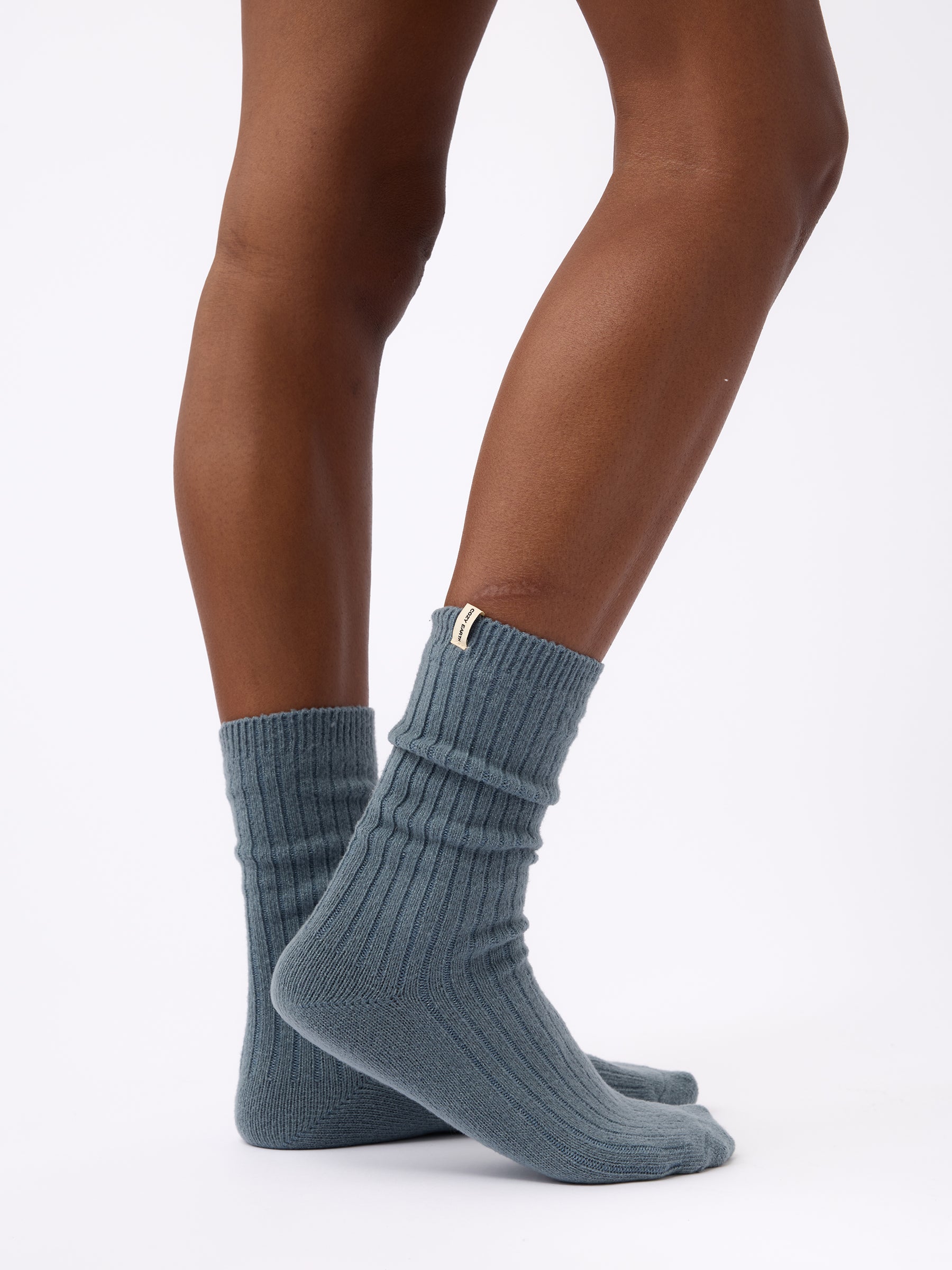 Person turned to the side wearing Cozy Earth Plush Lounge Calf Sock 1-Pack in Deep Blue |Color:Deep Blue