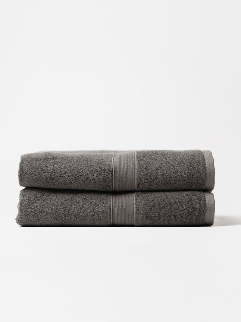 Two luxe bath sheets folded with white background