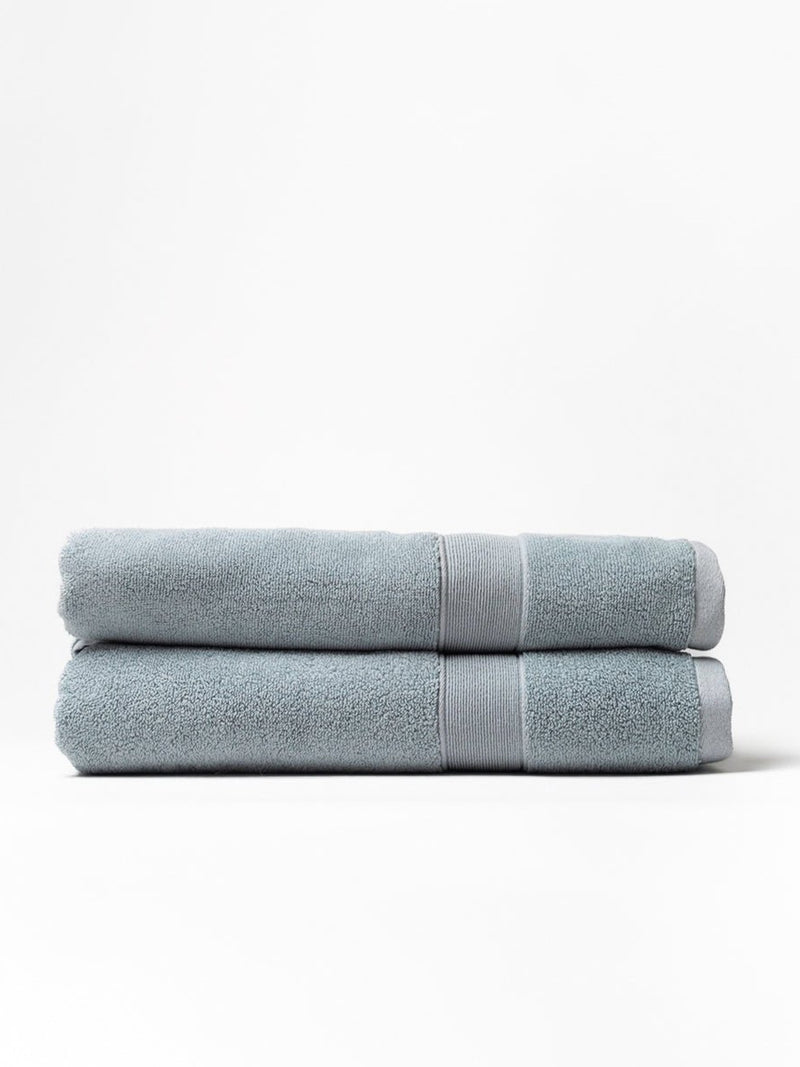 Two luxe bath sheets folded with white background