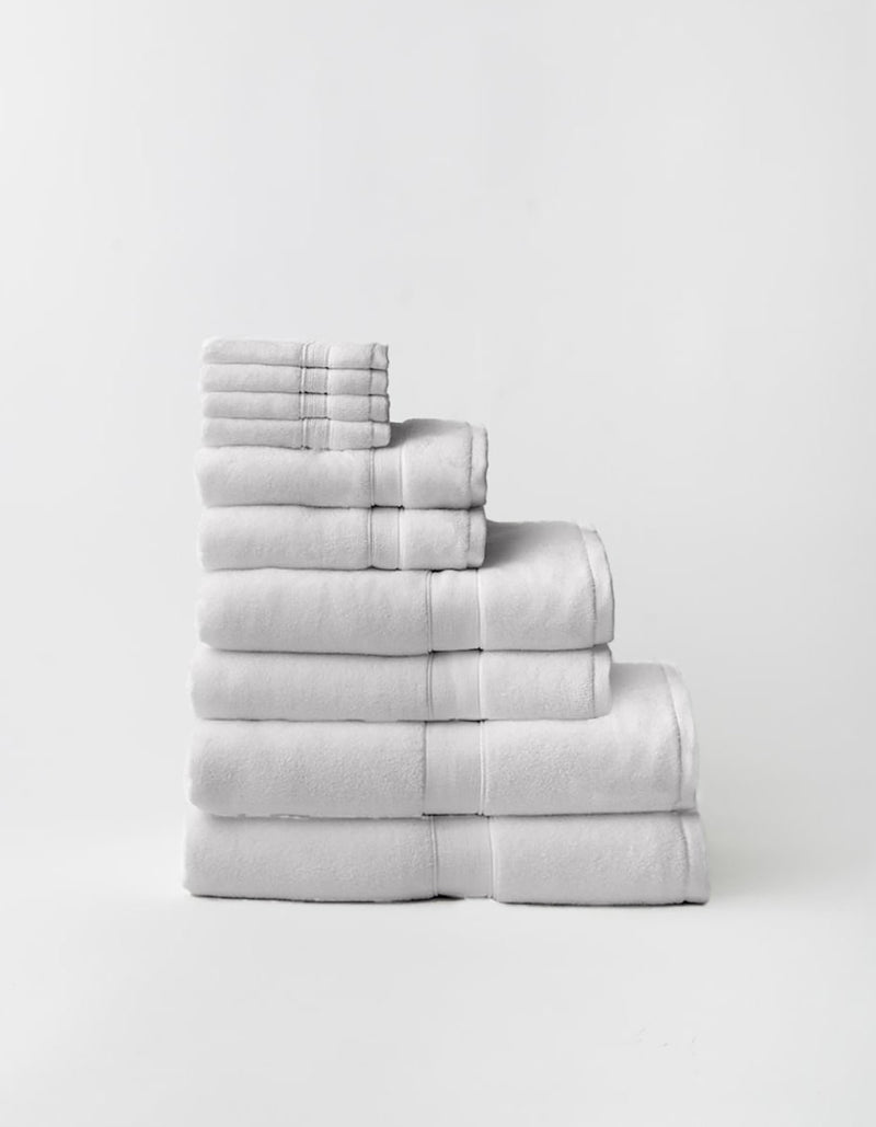 Stack of Cozy Earth Complete Luxe Bath Bundle is light gray on a white background