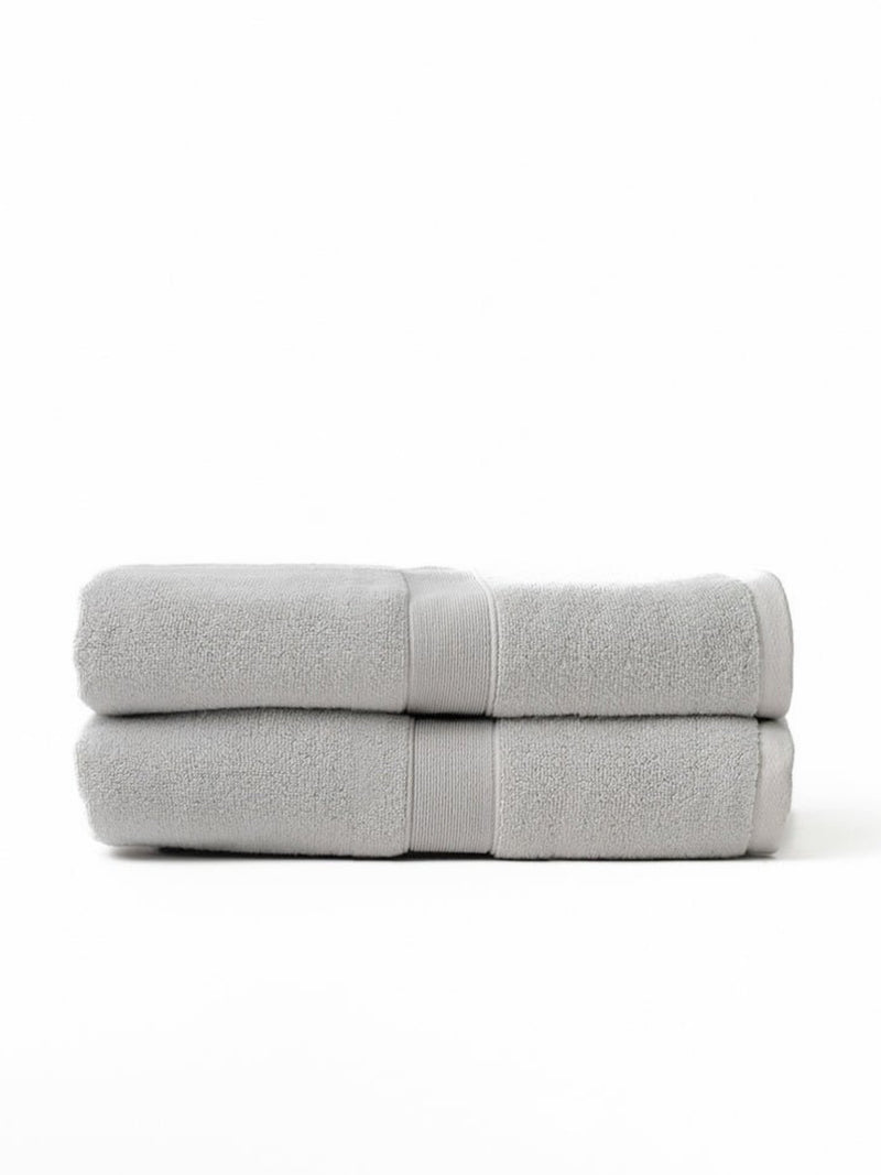 Two luxe bath sheets folded with white background