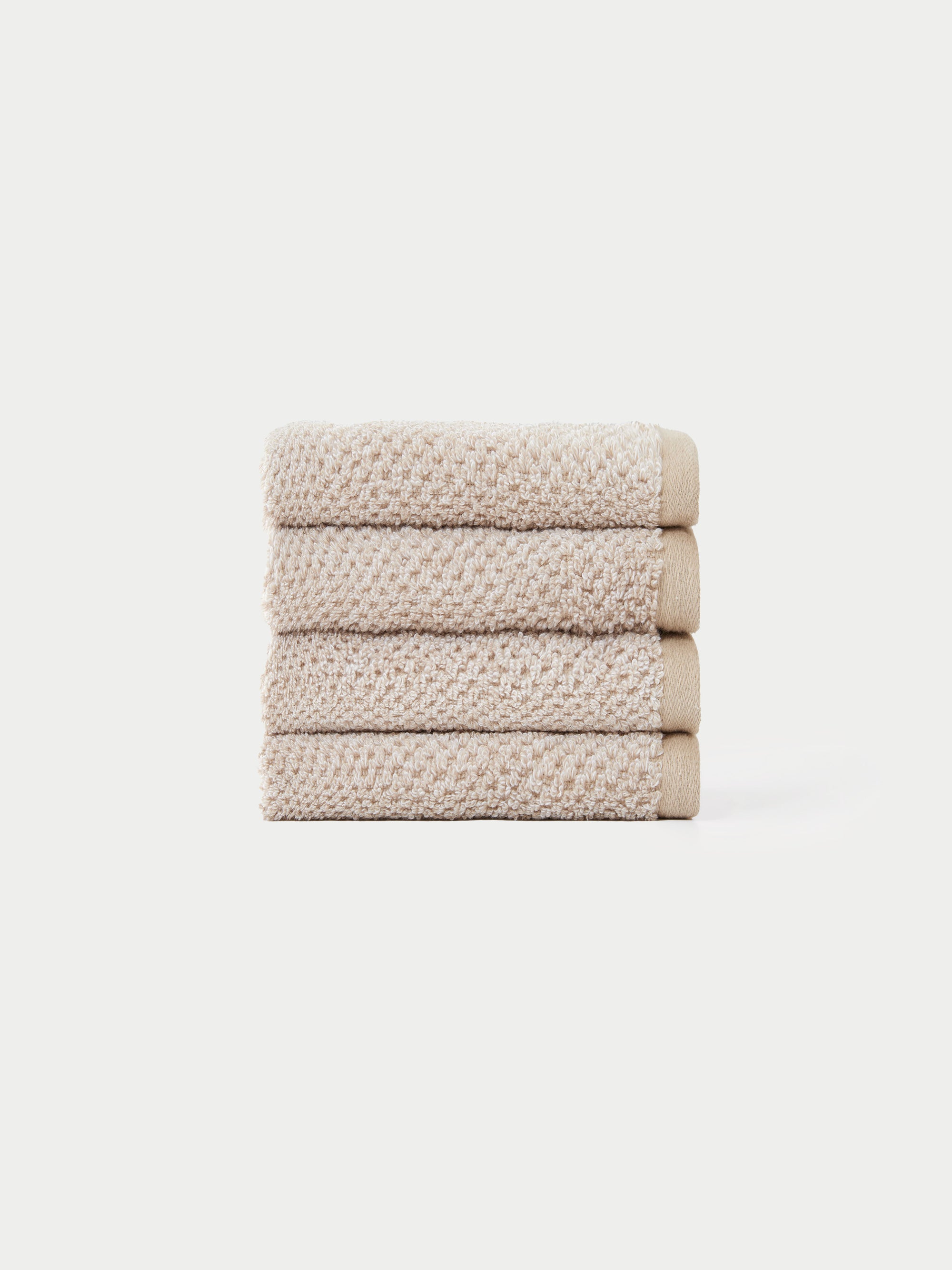 Nantucket Wash Cloths in the color Heathered Sand. The Wash Cloths are neatly folded. The photo of the wash cloths was taken with a white background.