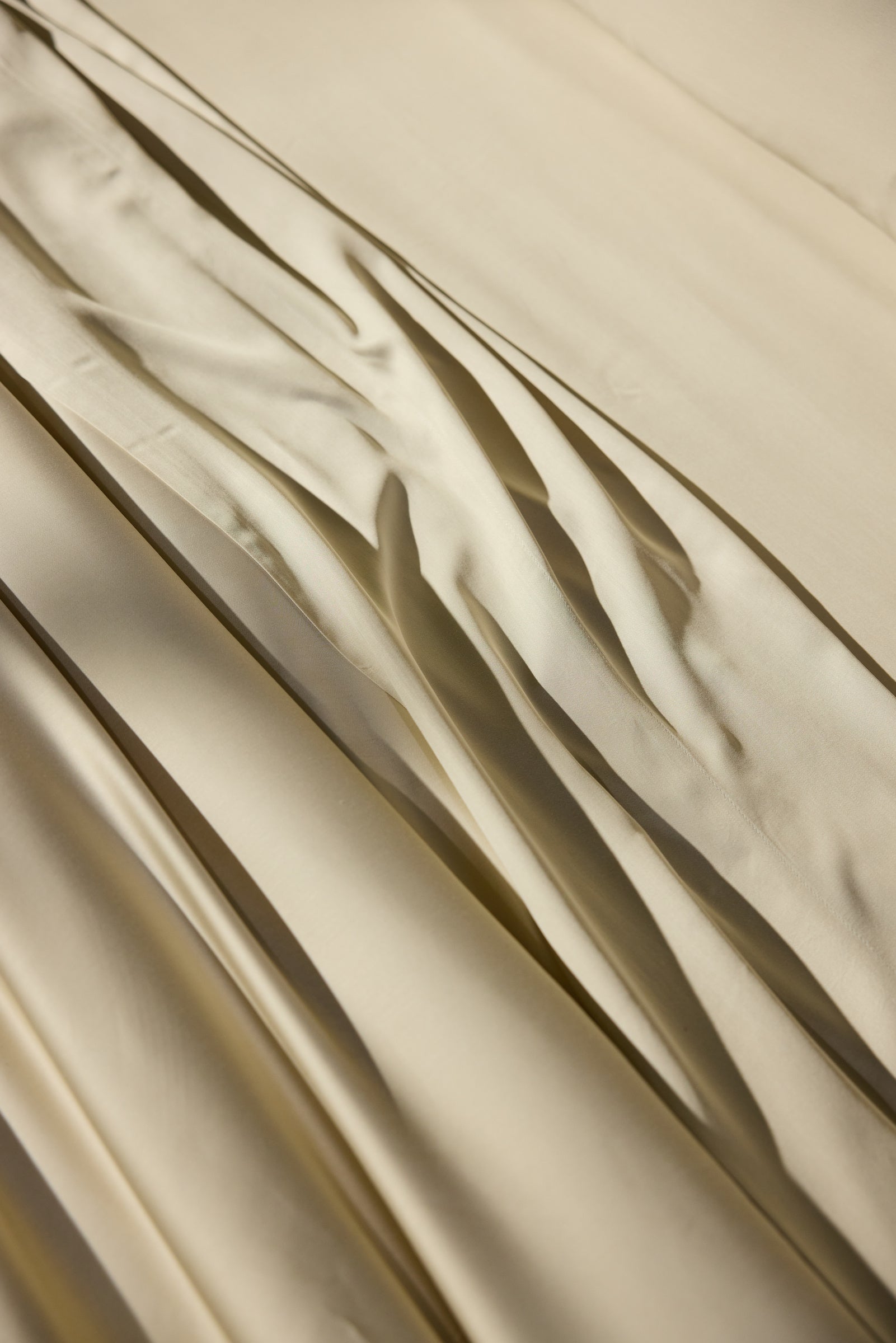 Close-up of beige fabric with folds