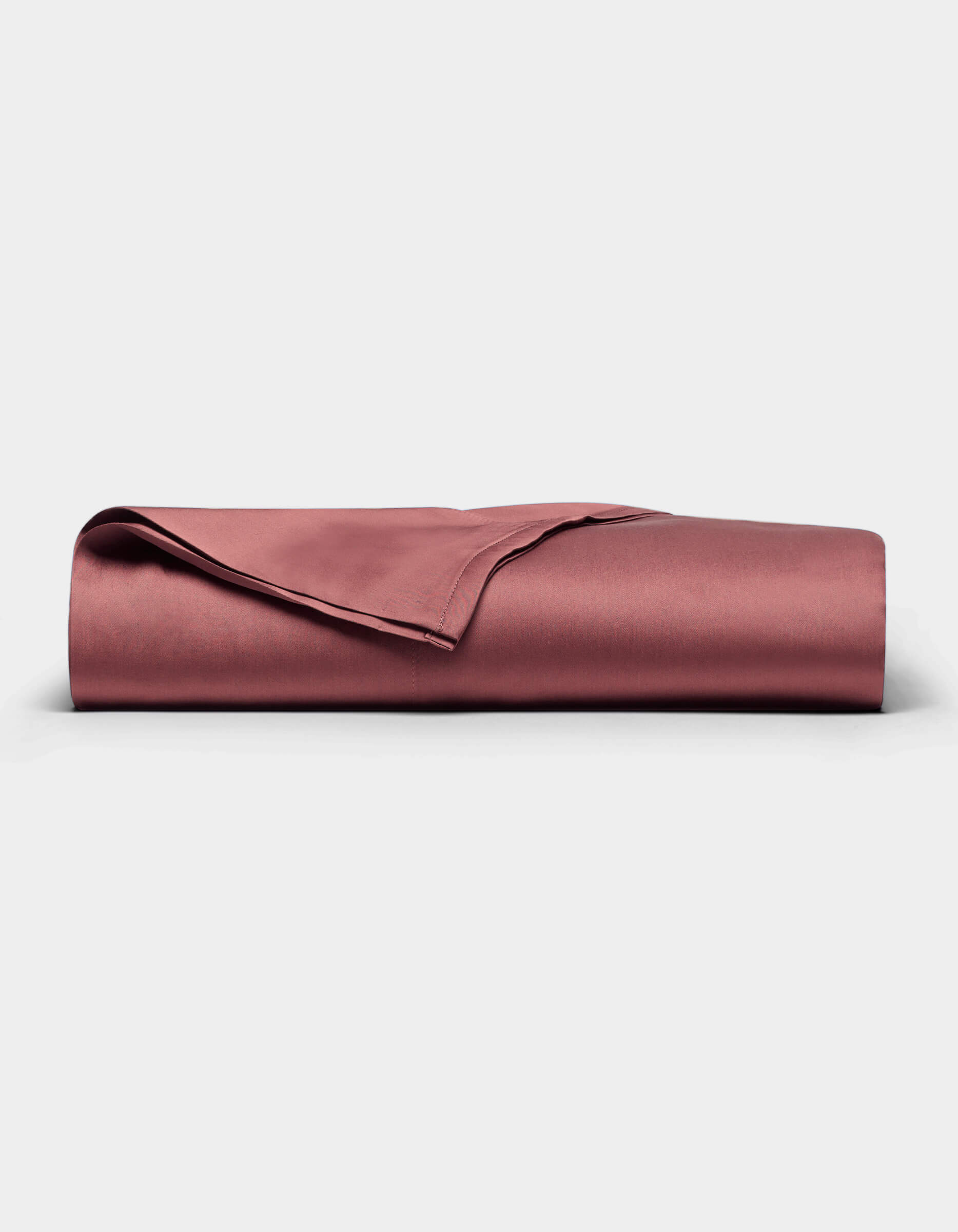 A Cozy Earth Bamboo Flat Sheet in a rose color is neatly folded and displayed on a plain white background. 