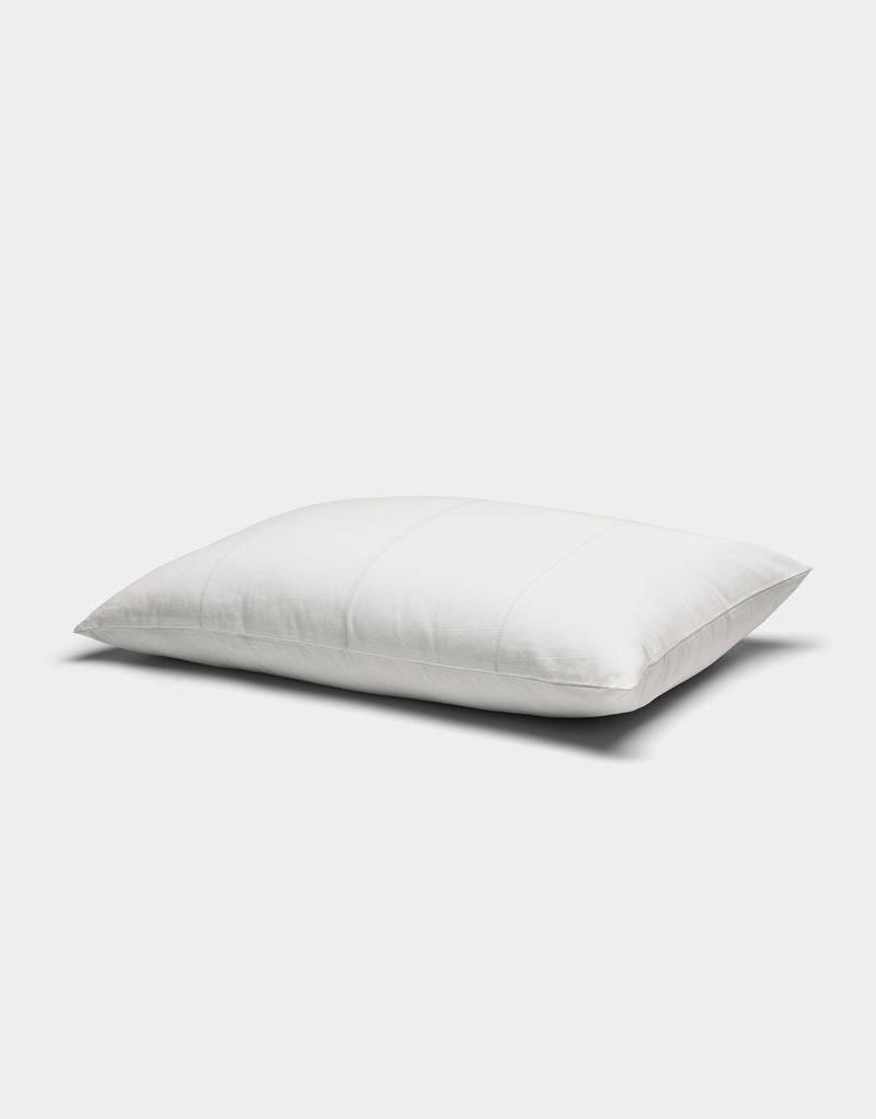 The Baja Double Sided Sham by Cozy Earth is a white, rectangular pillow with subtle horizontal stitching, displayed against a plain light gray background.
