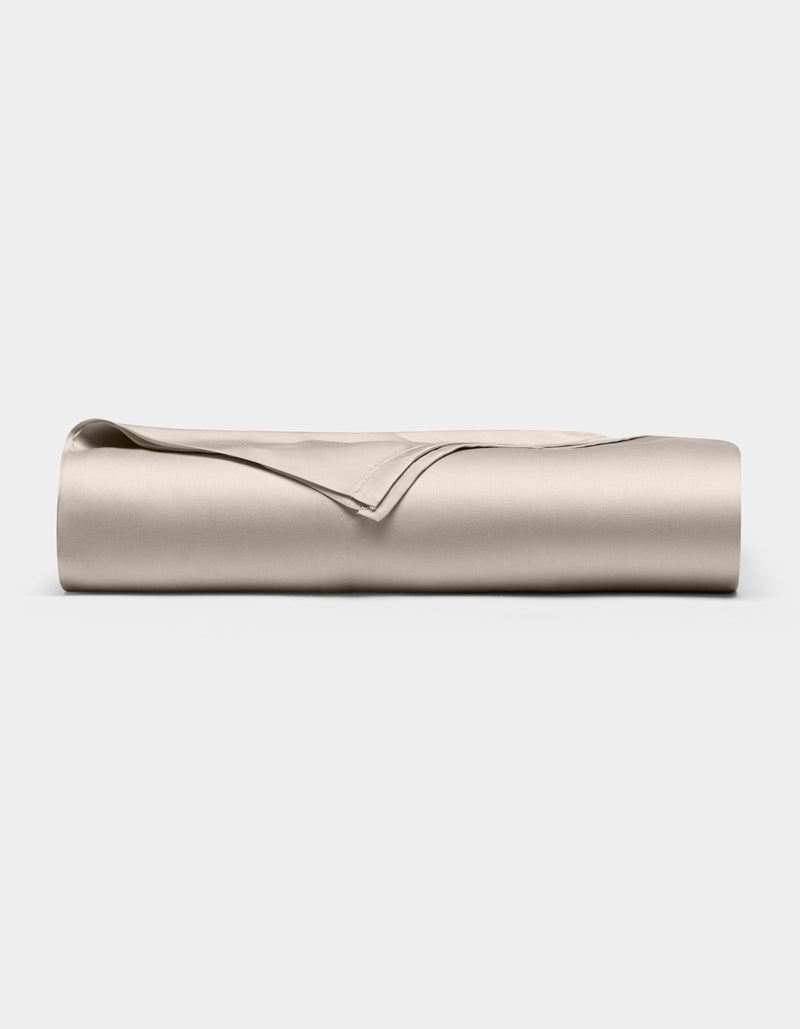The Cozy Earth Bamboo Flat Sheet, neatly folded in light beige, is displayed on a plain white background.