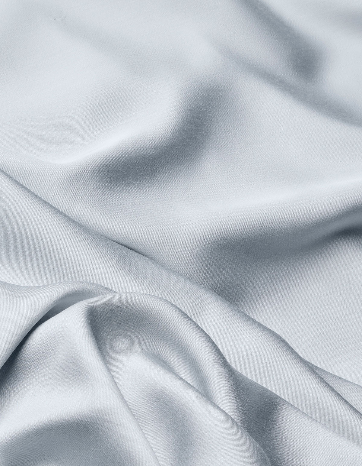 The Cozy Earth Bamboo Flat Sheet in light gray features a silky, smooth texture with soft folds and gentle shadows, adding movement and elegance to your bedding.|Color:Shore