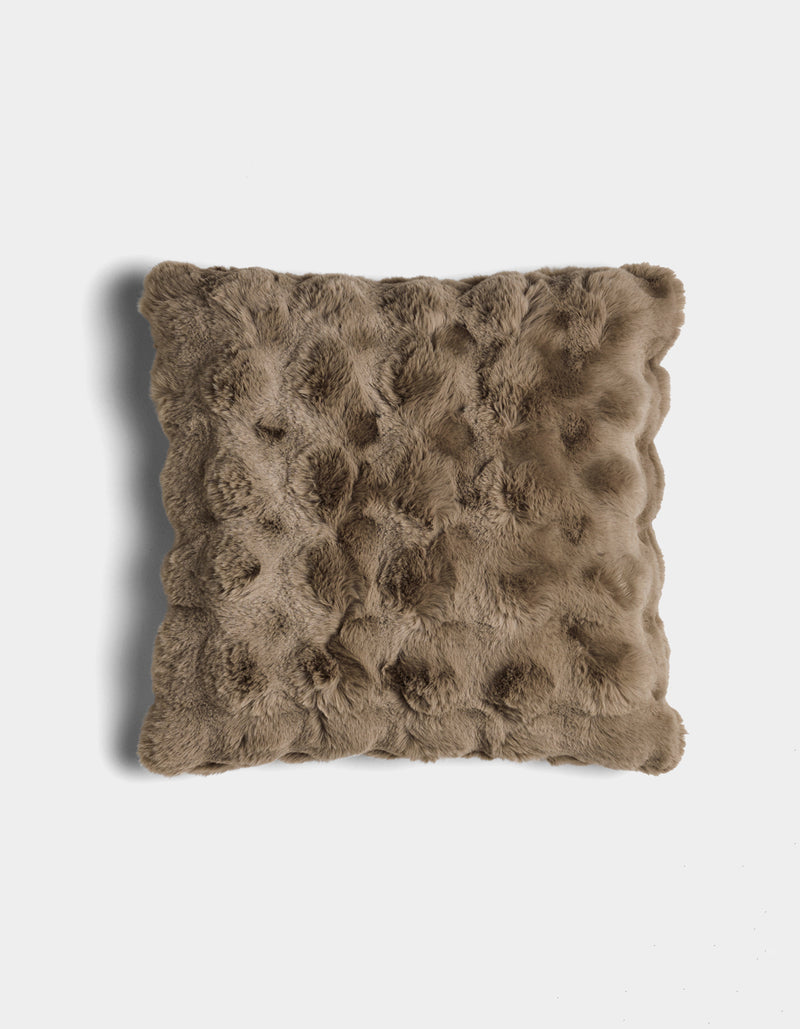 The Bubble Cuddle Pillow by Cozy Earth is a square, brown faux fur pillow with a textured, tufted surface, shown against a white background.