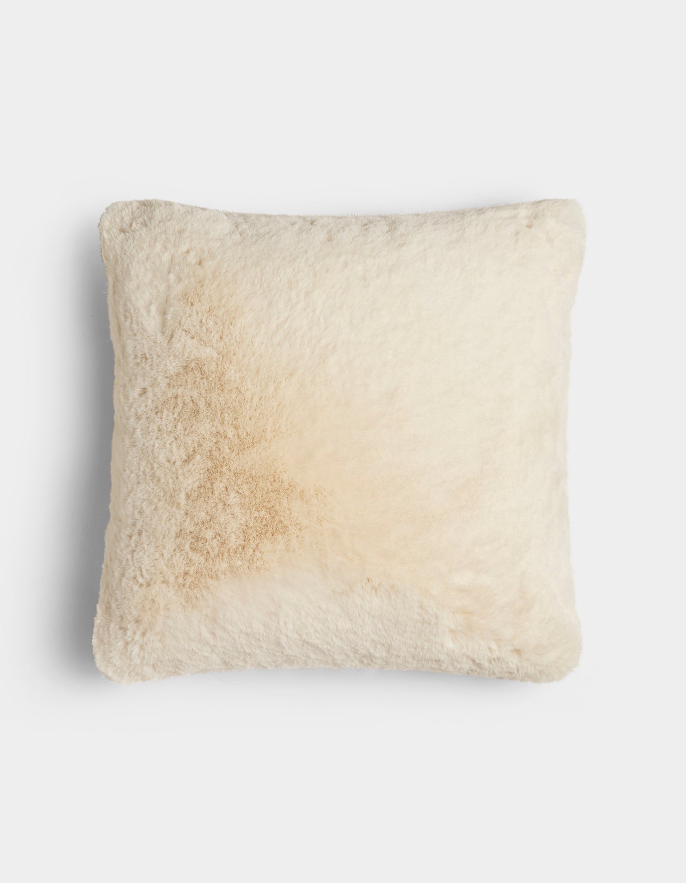 The Cuddle Pillow by Cozy Earth is a square, cream-colored, fluffy pillow featuring a light tan stain on the left side, shown against a plain white background.|Color:Creme |Size:24" x 24"