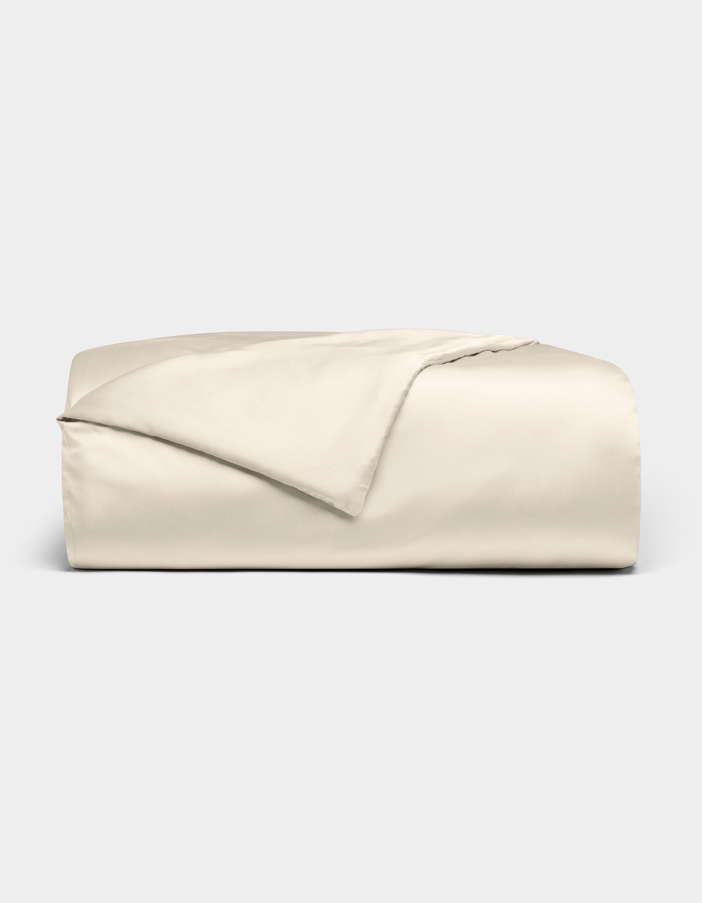 The Cozy Earth Bamboo Duvet Cover is shown neatly folded in light beige, with one corner turned back, set against a plain light gray background.|Color:Creme