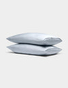 Two Cozy Earth Bamboo Pillowcases in light gray are stacked neatly against a plain, light gray background.|Color:Shore