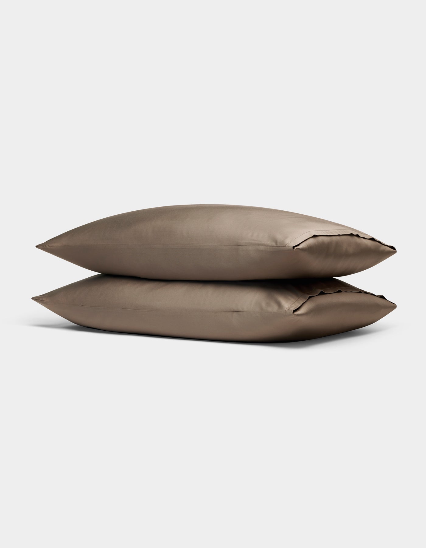 Two Cozy Earth Bamboo Pillowcases in taupe, rectangular and neatly stacked on top of each other, are displayed against a plain light gray background.|Color:Walnut