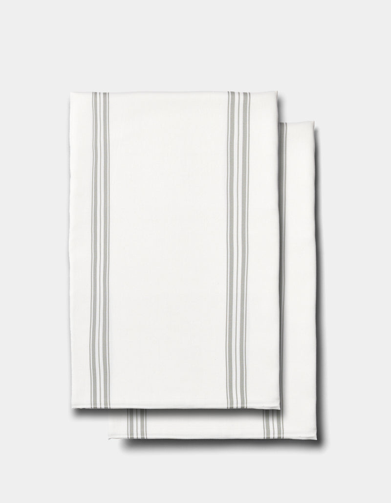 Two neatly folded Cozy Earth Bamboo Pillowcases in white, featuring thin gray vertical stripes along the edges, displayed on a plain light gray background.