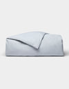 The Cozy Earth Soft-Wash Cotton Duvet Cover set, in light blue, is neatly folded and displayed against a plain white background.|Color:Shore