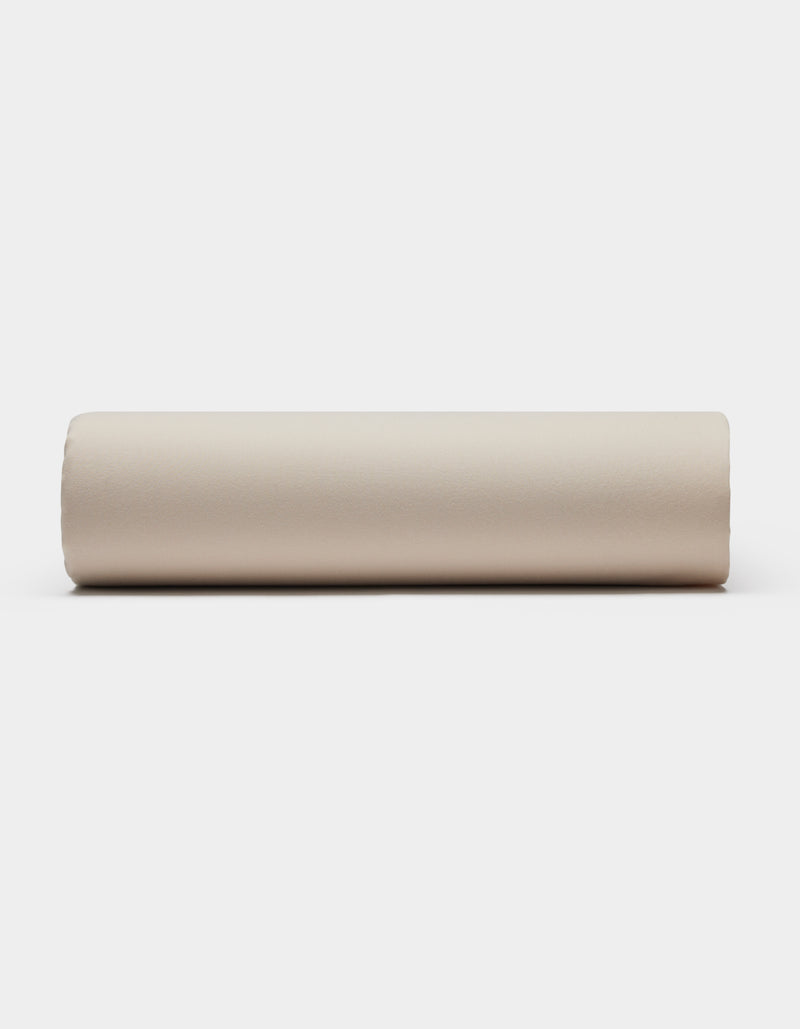 A Soft-Wash Cotton Sheet Set by Cozy Earth is displayed on a plain white background, viewed directly from the side.