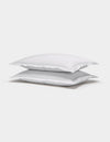 Two Cozy Earth Soft-Wash Cotton Shams are stacked neatly on top of each other against a plain white background.|Color:White