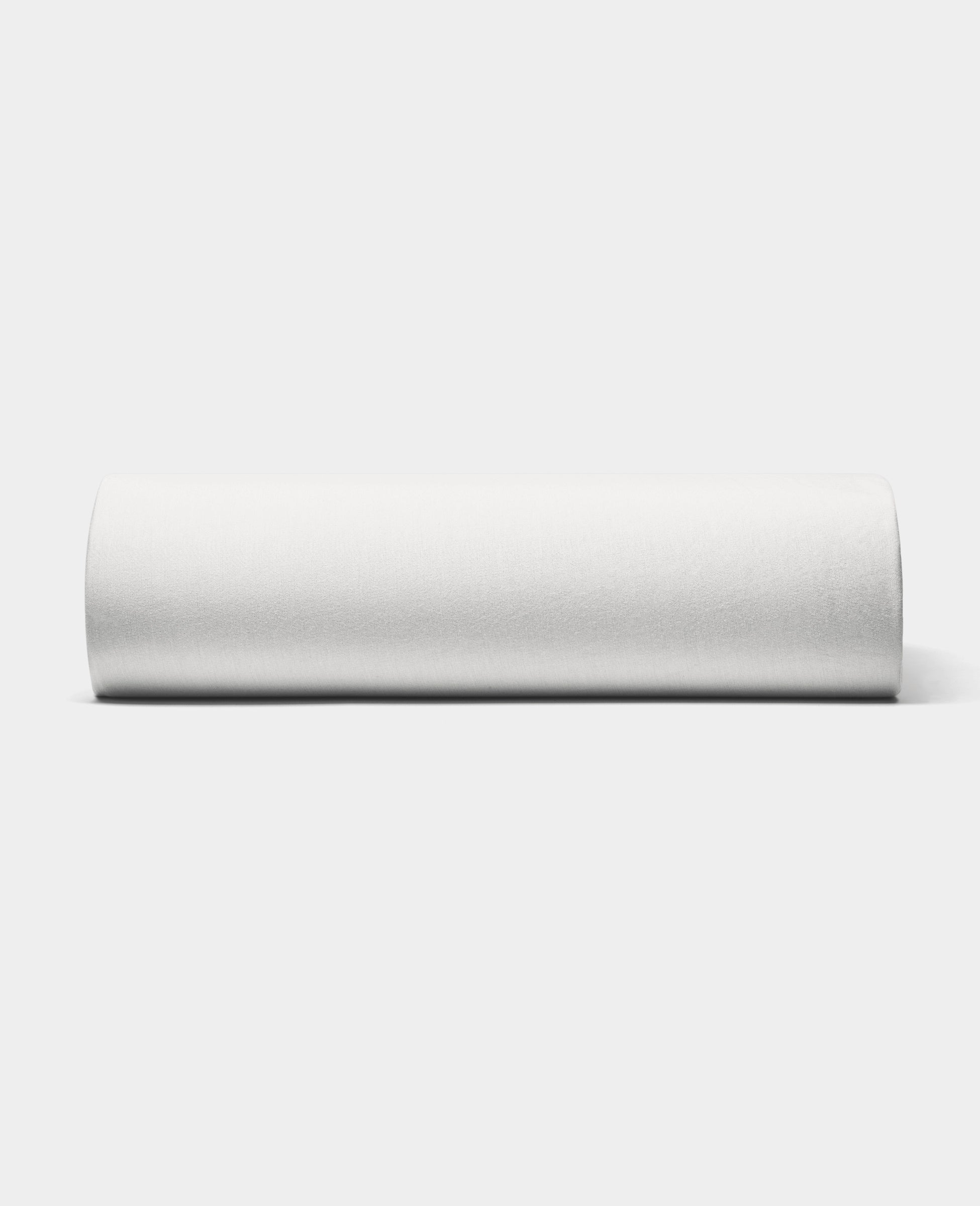 The Cozy Earth Bamboo Jersey Fitted Sheet is displayed against a light gray background, highlighting its smooth fabric and snug fit on the mattress.|Color:White