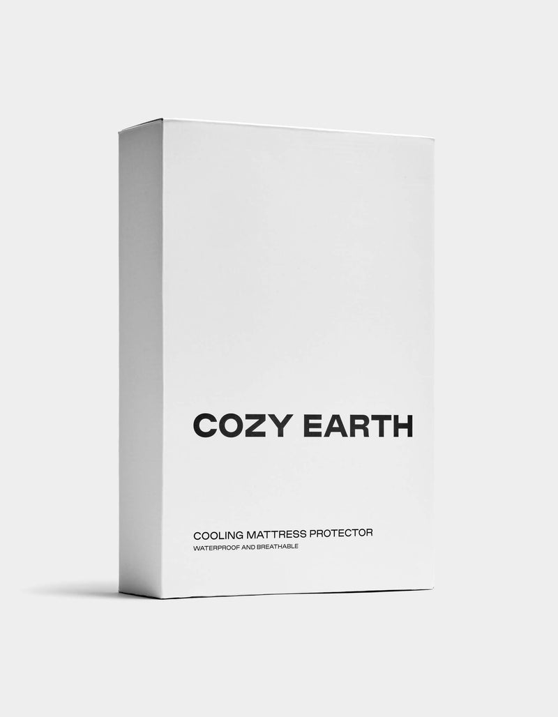 A minimalist white rectangular box features "COZY EARTH" in bold black letters, "Cooling Mattress Protector" below, and "Waterproof and Breathable" in smaller text on the clean packaging.