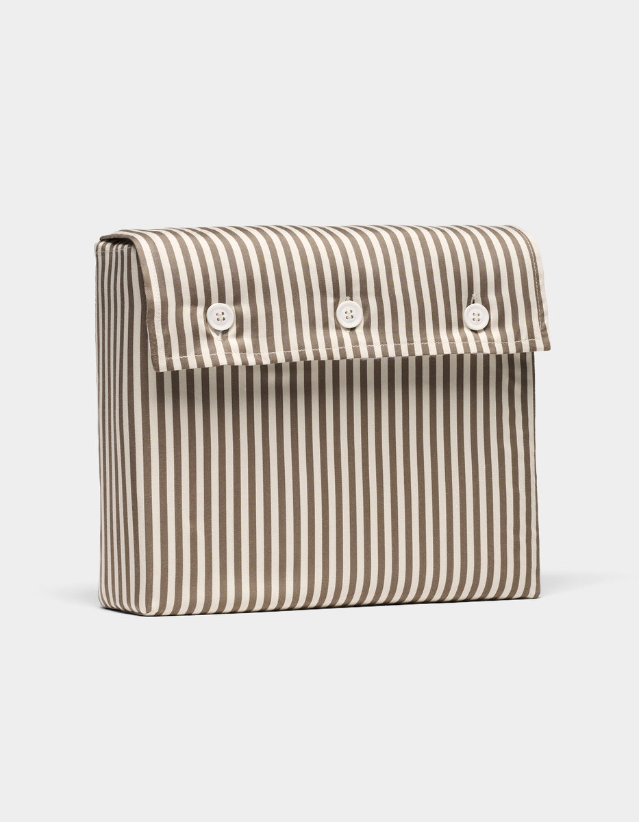 The Bamboo Sheet Set by Cozy Earth comes in a rectangular pouch with vertical blue and white stripes and a front flap secured by three white buttons.