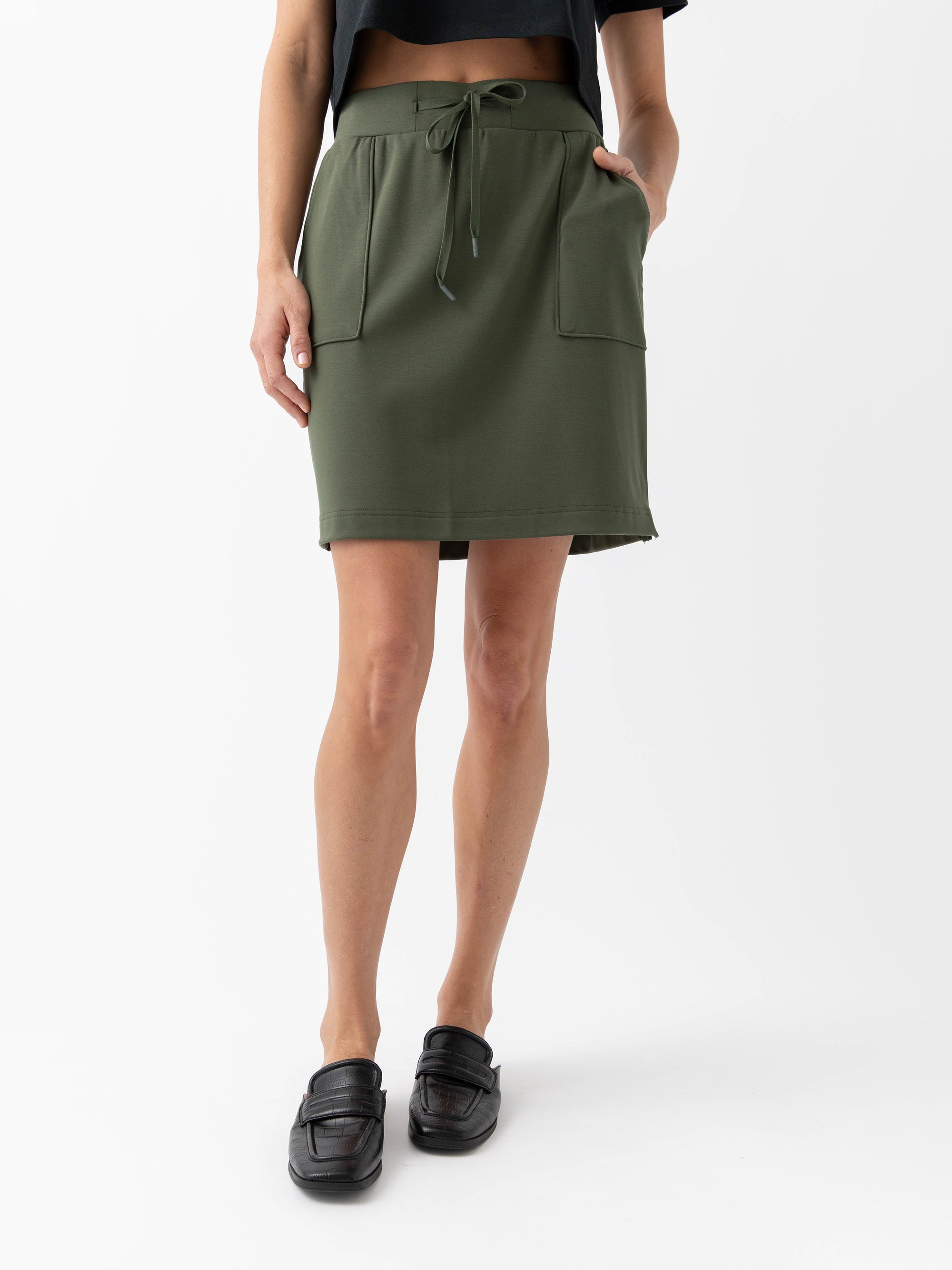 Person wearing a Cozy Earth Brushed Bamboo Patch Pocket Skirt in green on a white background 