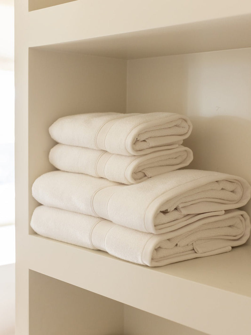 Seashell towels folded on shelf