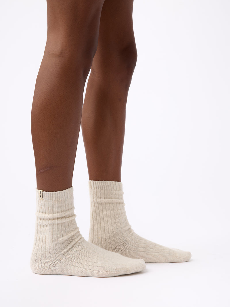 Person wearing Cozy Earth Plush Lounge Calf Sock 1-Pack in Alabaster