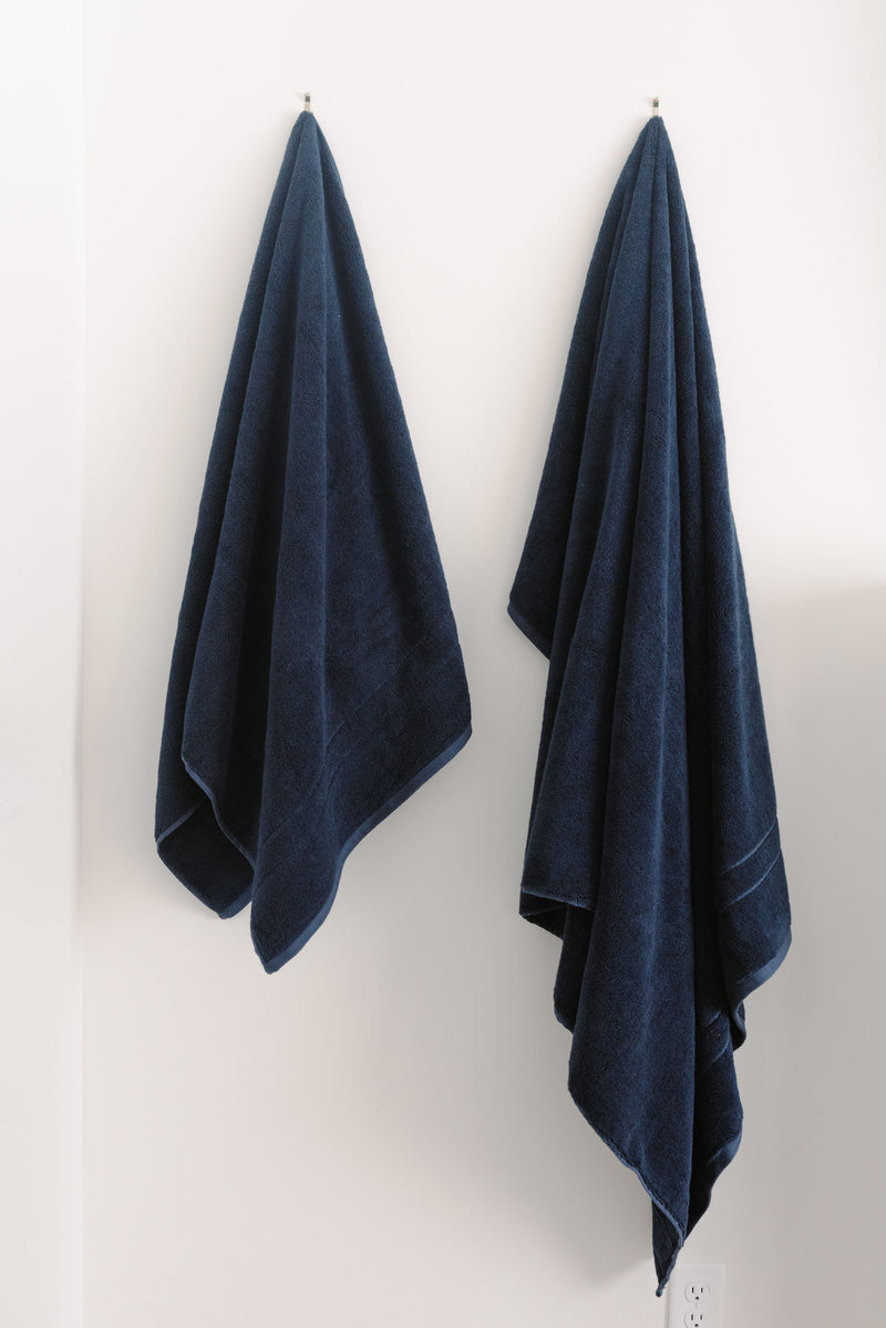 Premium Plush Bath Towels/sheets in the color dusk. Photo of Premium Plush Bath Towels taken in a bathroom showing the towels which are hung from a towel rack.