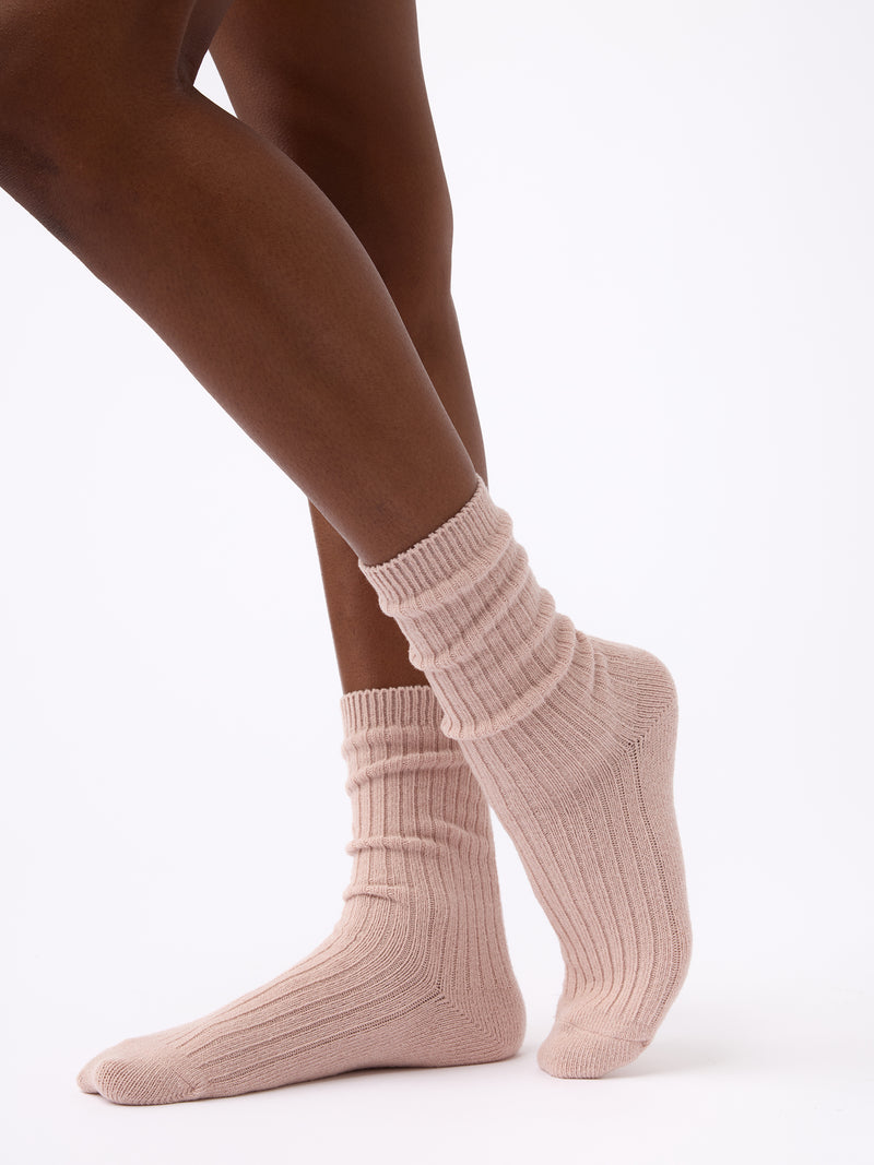 Person turned to the side wearing Cozy Earth Plush Lounge Calf Sock 1-Pack in Dusty Rose