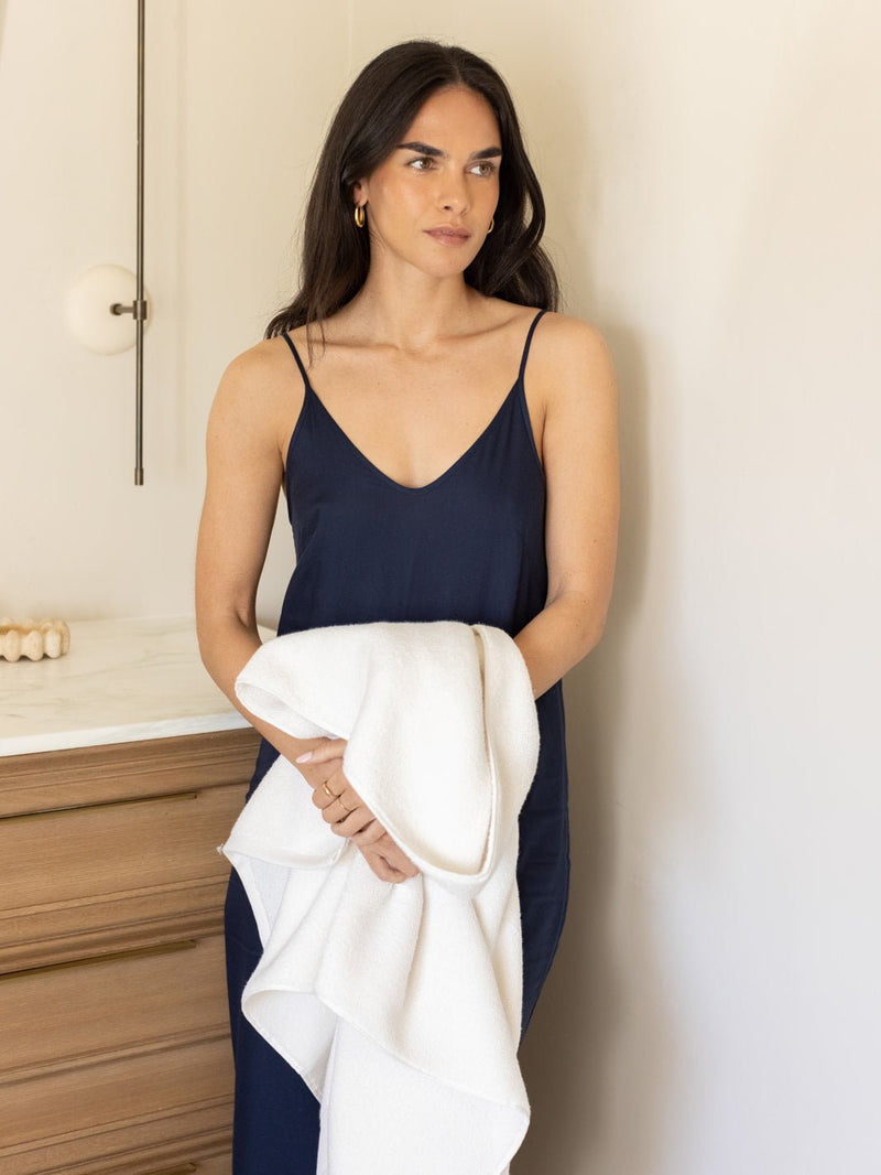 Woman holding seashell luxe bath sheet