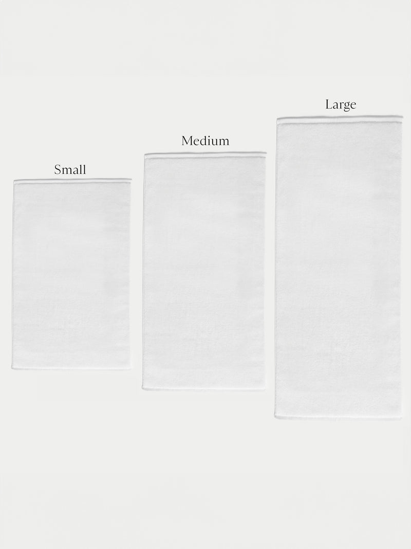 Three Cozy Earth Loop Terry Bath Mats of different sizes are arranged side by side on a plain background, labeled from left to right as Small, Medium, and Large.
