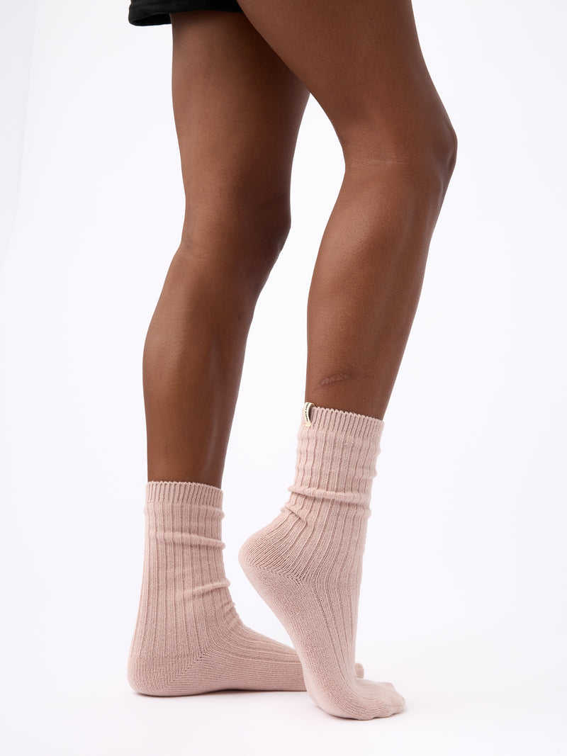 Person turned to the side wearing Cozy Earth Plush Lounge Calf Sock 1-Pack in Dusty Rose