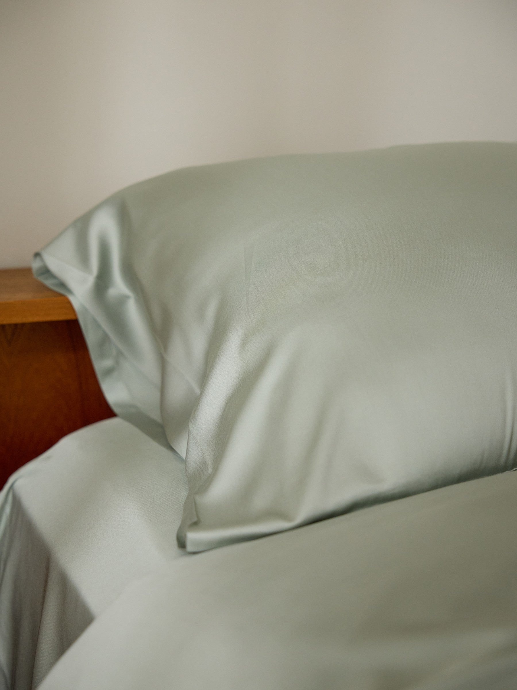Nicely made bed with laurel bedding standard/king. |Color:Laurel
