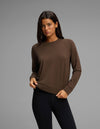 A woman with long dark hair is wearing the Cozy Earth Women's Brushed Bamboo Pullover Crew in brown and black leggings, standing against a plain gray background.|Color:Espresso