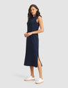 A woman in a Cozy Earth Women's Brushed Bamboo Sleeveless Midi Dress and white sneakers stands against a plain light gray background. |Color:Navy
