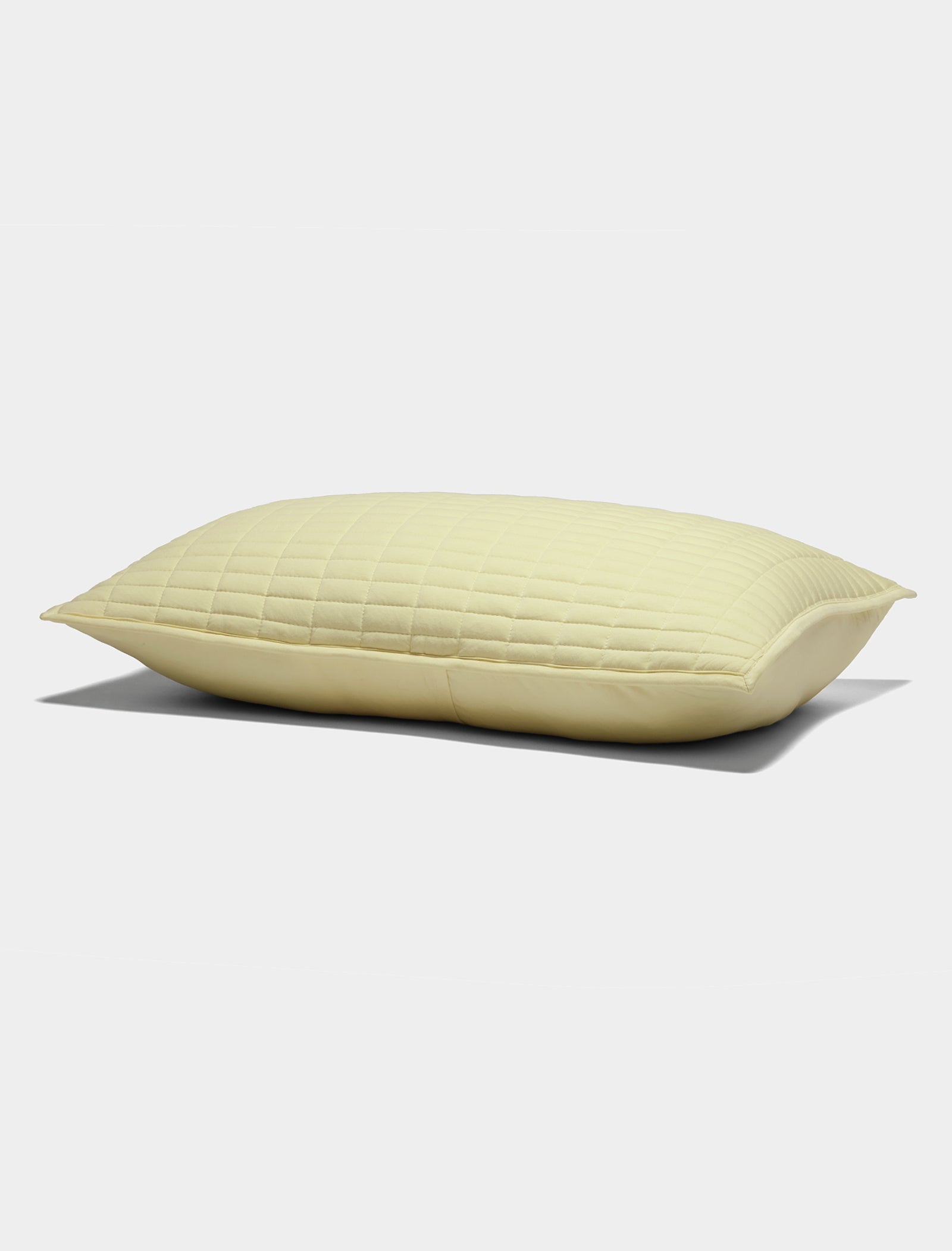 The Cozy Earth Bamboo Jersey Quilted Shams in light yellow, featuring a smooth quilted texture, are displayed against a plain white background.|Color:Meringue