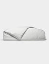 A neatly folded Bamboo Duvet Cover by Cozy Earth, featuring light gray and white stripes with one corner flipped open, is displayed against a plain white background.|Color:Classic Stripe in Dew
