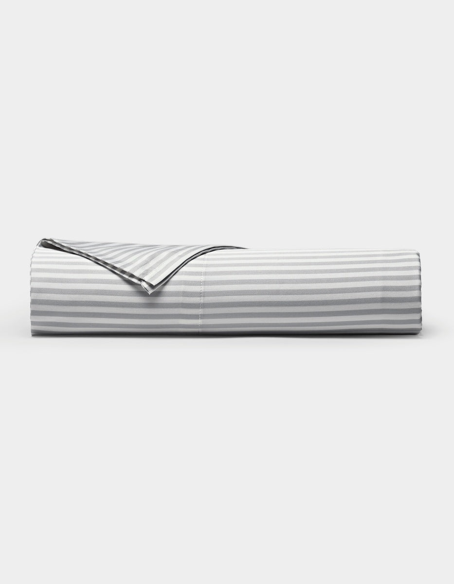 A neatly folded Cozy Earth Bamboo Flat Sheet in a gray and white striped pattern is displayed against a plain white background.|Color:Classic Stripe in Dew
