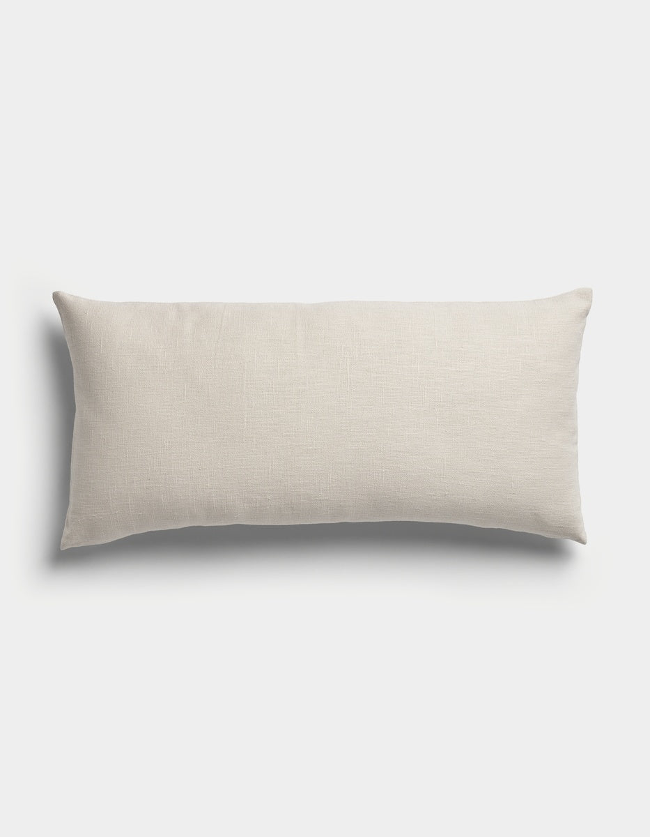 The Sonoma Throw Pillow by Cozy Earth is a rectangular pillow in light beige, featuring a plain, smooth fabric and displayed against a white background.