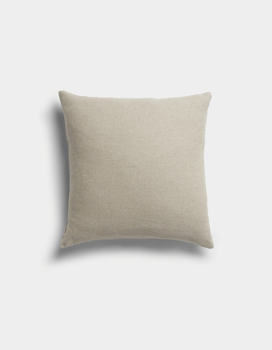 The Sonoma Throw Pillow by Cozy Earth is a square, beige pillow with a soft fabric texture, displayed against a light gray background with a faint shadow on the left side.