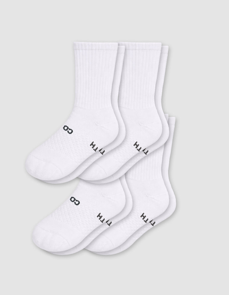 Cozy Earth Men's Essential Calf Sock 4-Pack in white, featuring black text near the toes, displayed on a light gray background.