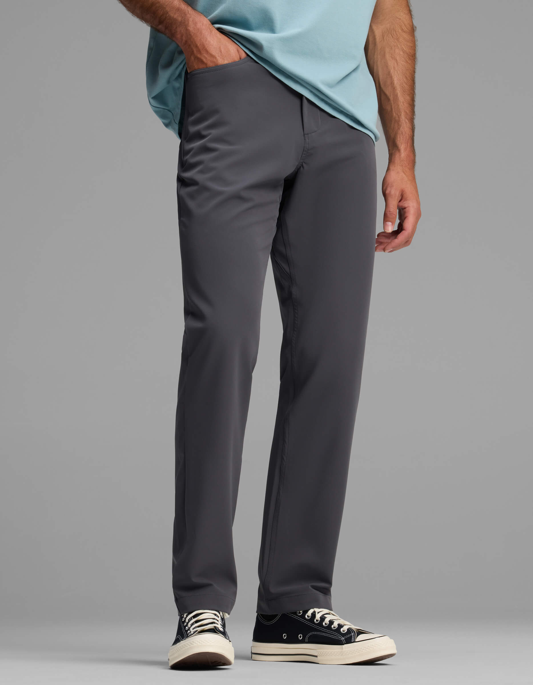 A person stands against a plain gray background, wearing only the Men's Everywhere Pant - Relaxed Fit by Cozy Earth, visible from the waist down.