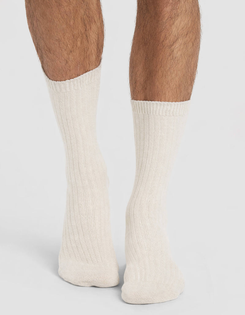 A person wearing Cozy Earth Men's Plush Lounge Calf Socks, standing with their feet close together on a plain background.