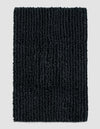The Cozy Earth Plush Loop Bath Mat, rectangular and dark gray with thick textured fibers, is displayed on a plain light gray background.|Color:Graphite