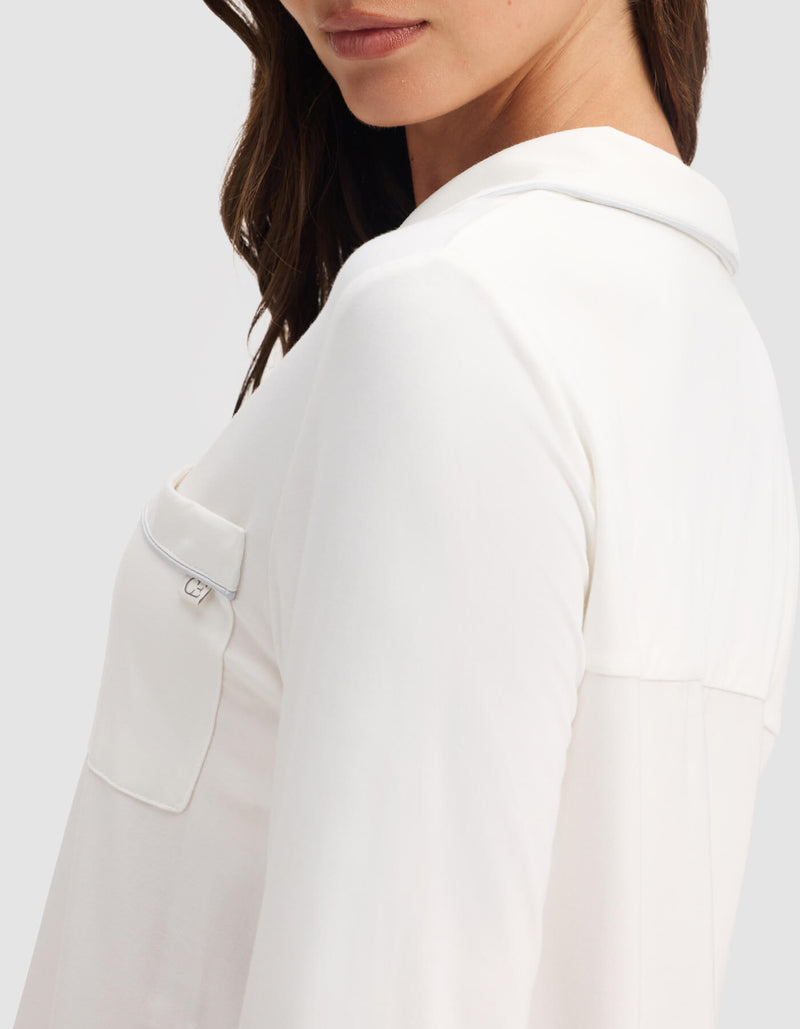 A woman in a Cozy Earth Women's Bamboo Stretch-Knit Long Sleeve Pajama Top with a chest pocket, shown from the side and her face partially visible.