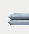 Two Cozy Earth Bamboo Pillowcases in Harbor Mist stacked on top of each other against a plain, light gray background.|Color:Harbor Mist