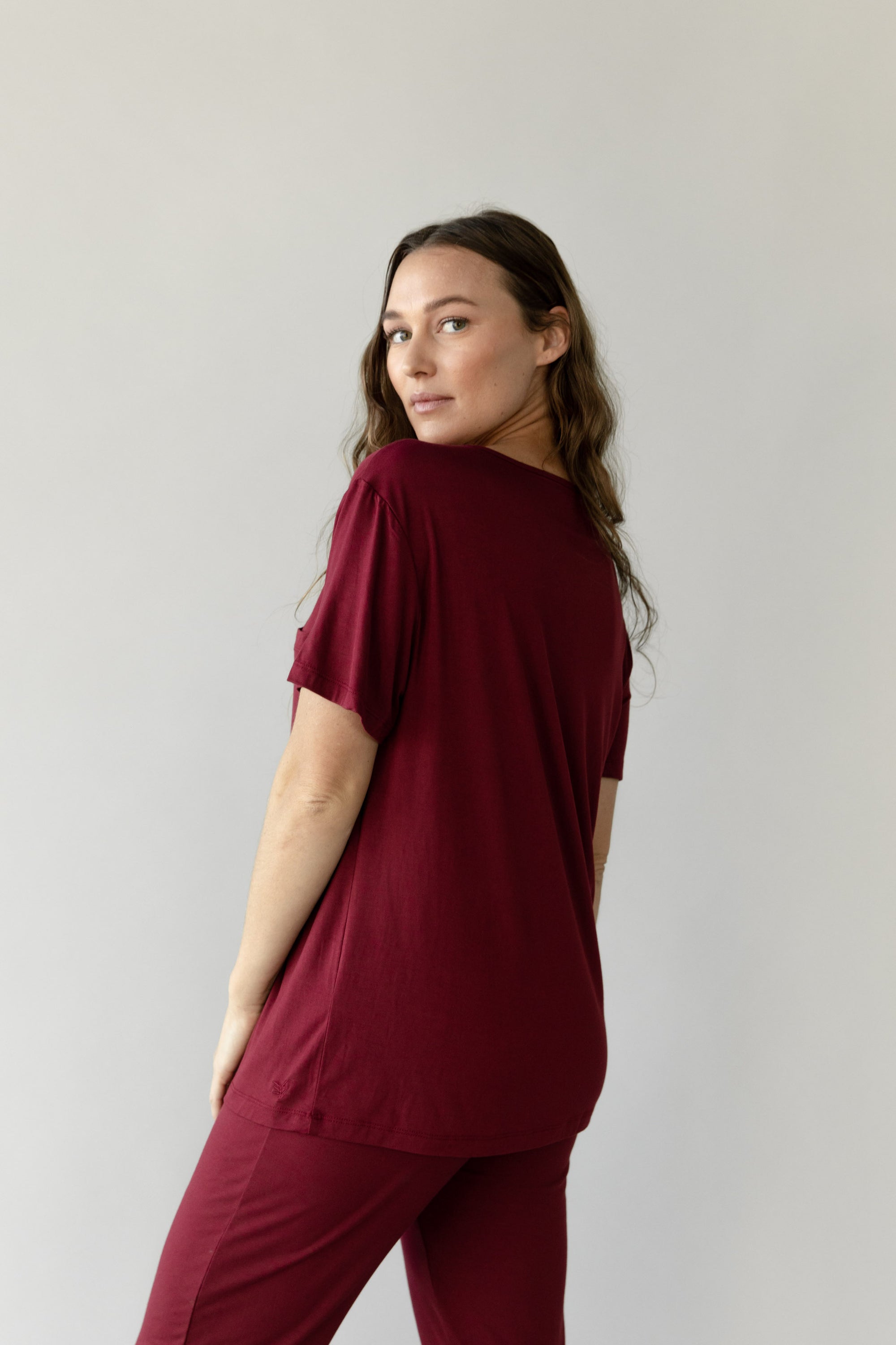 Woman wearing Cozy Earth Bamboo Lounge Tee in dark burgundy 
