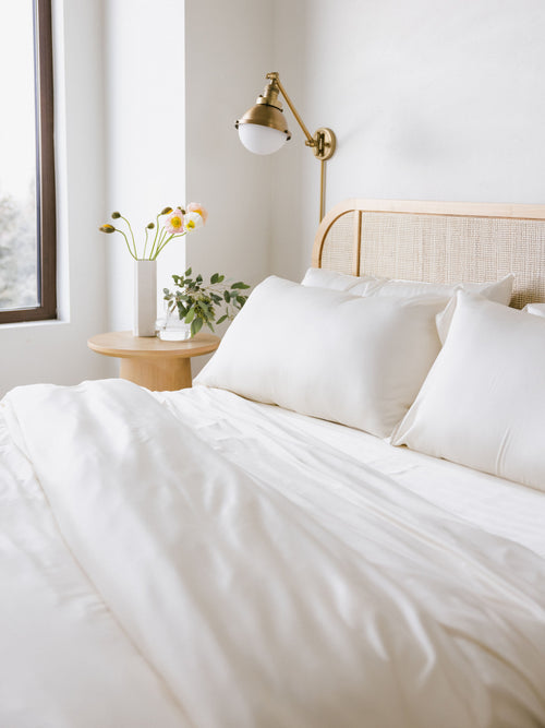 Partially made bed with creme bedding |Color:Creme