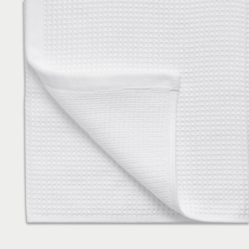 Waffle Bath Towel in the color White. Photo of Waffle Bath Towel taken close up showing the corner of the towel