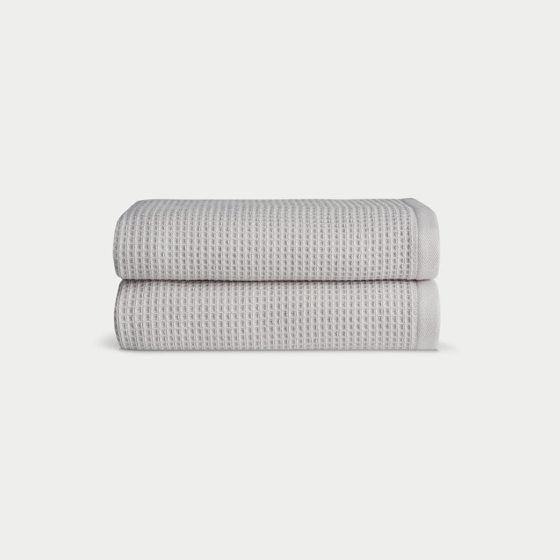 Light Grey Waffle Hand Towel set neatly folded. The photo was taken with a white background.