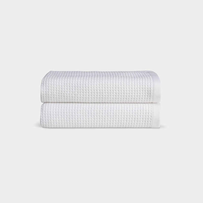 White Waffle Hand Towel set neatly folded. The photo was taken with a white background.